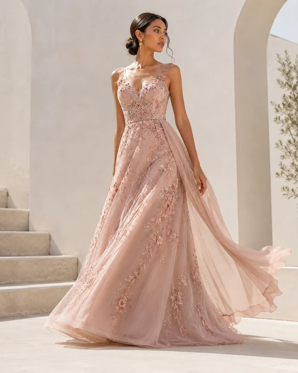 Blush couture evening dress with floral embroidery and a flowing skirt